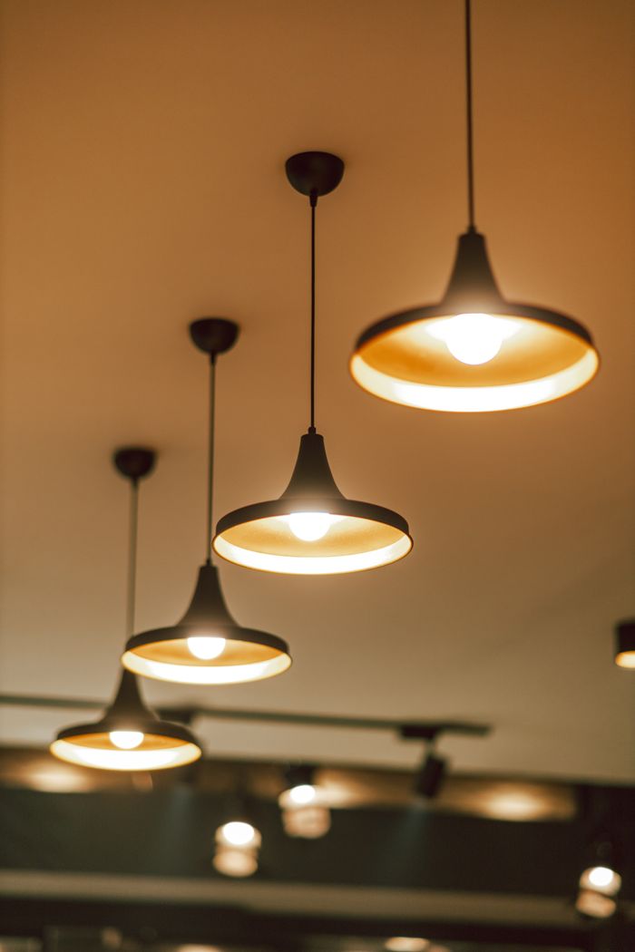 A warm interior featuring a row of modern pendant lights creating a cozy ambiance.